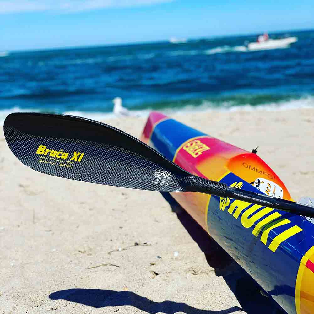 Braca XI Surfski paddle on Cape Cod beach in front of a Surfski 