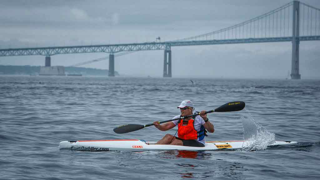 Image of a person in Nelo 520 surfski going under the Newport Bridge