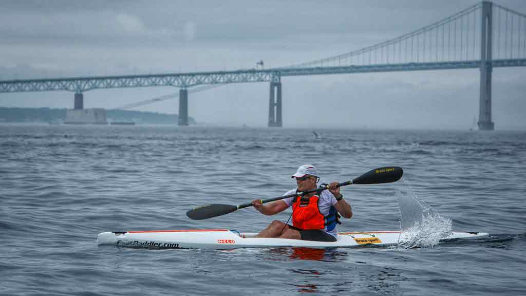 chris-520-ri-res Image of a person in Nelo 520 surfski going under the Newport Bridge