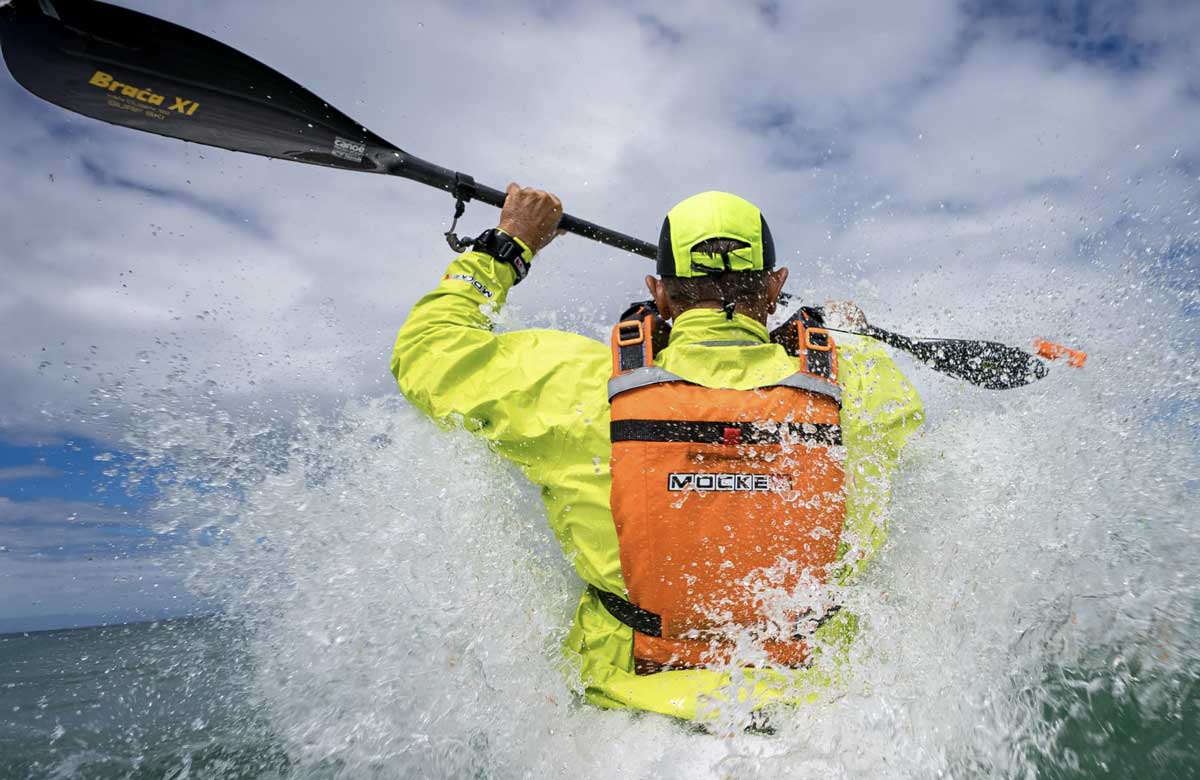 Mocke PFD on a surfskier going over a wave.